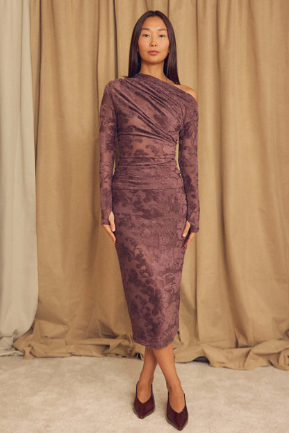 Model wearing the Cocoa Devoré Drape Top with a unique draped design and abstract pattern.