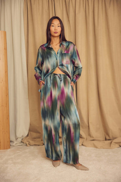 A model wearing Printed ECOVERO Viscose Barrel-Leg Trousers in a stylish setting.
