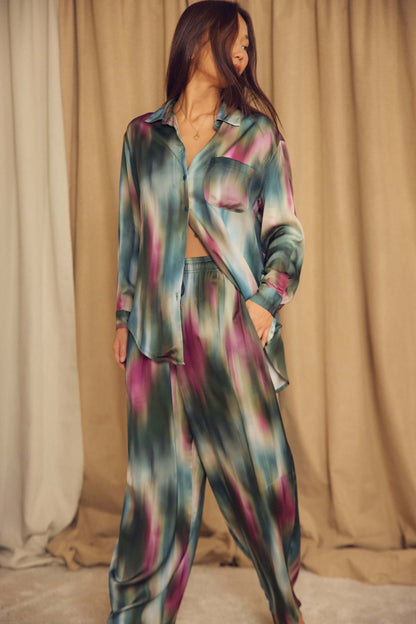 Model wearing Printed ECOVERO Viscose Barrel-Leg Trousers with a colorful blouse, showcasing relaxed tailoring.