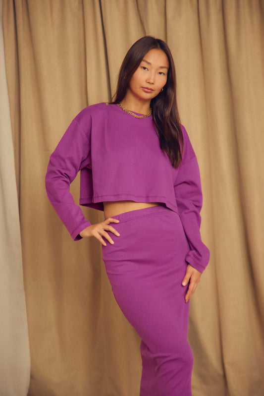 Model wearing Plum Organic Cotton Oversized Crop Top with matching skirt in a relaxed pose.