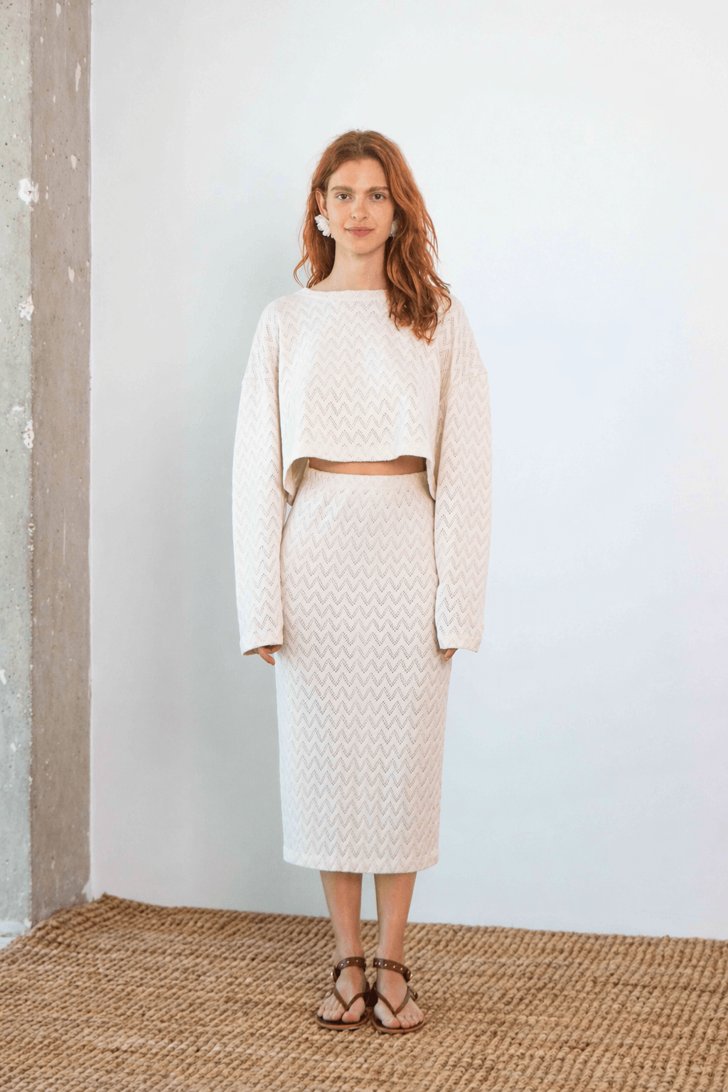 Crochet Organic Cotton Long Sleeve Top worn with matching skirt against a neutral background, showcasing its textured design.