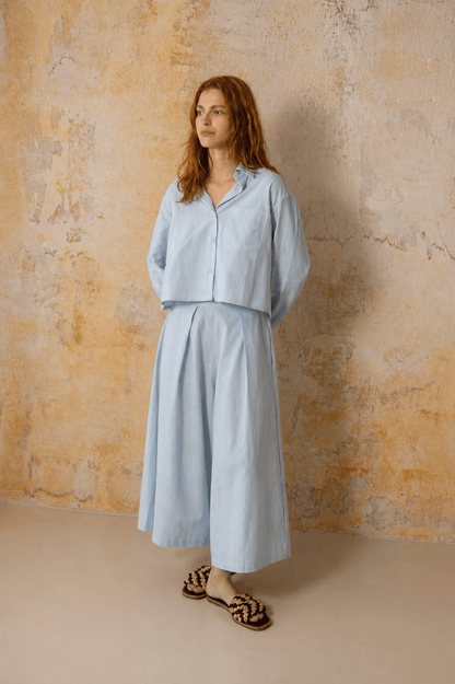 Model showcasing Organic Cotton Wide Culottes in Pale Blue, featuring a relaxed silhouette and cropped design.