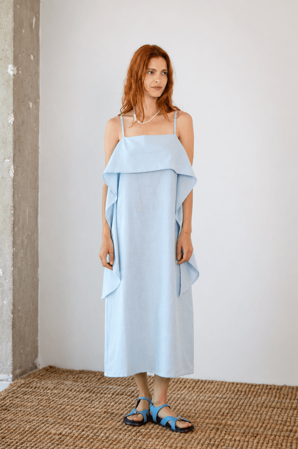 Organic Cotton Sun Dress with Front Frill in Pale Blue worn by a model, showcasing a relaxed silhouette and frill detail.