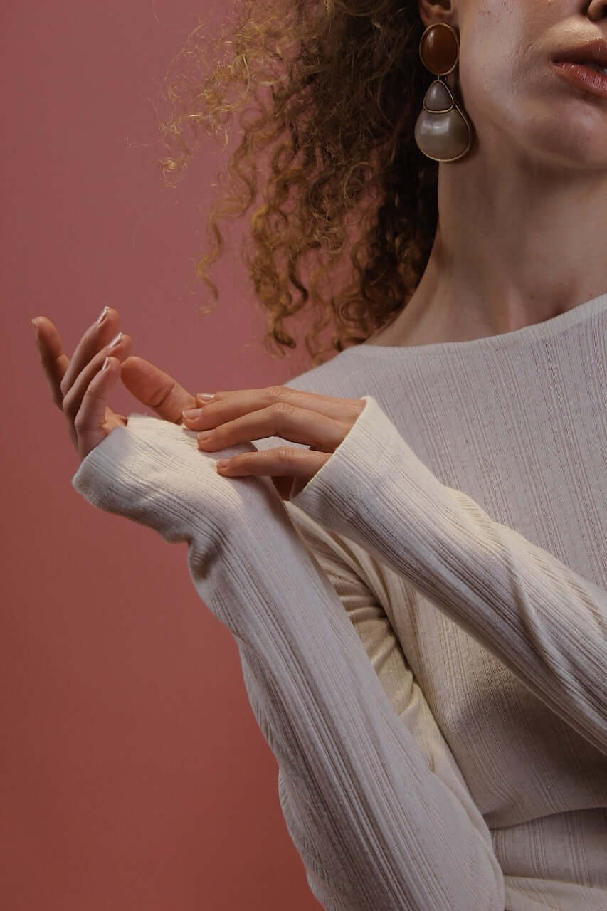 Banana Pineapple Multiway Wrap Top in Ecru worn by a model, showcasing the long sleeves and thumb hole detailing.