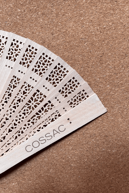 Wooden fan made from recycled wood, featuring intricate design and 'COSSAC' logo, size 30x30cm.
